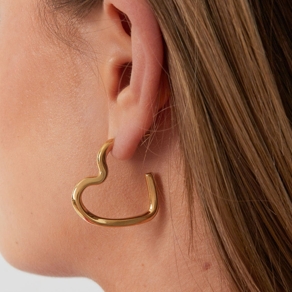 Gouden en zilveren open hart oorbellen